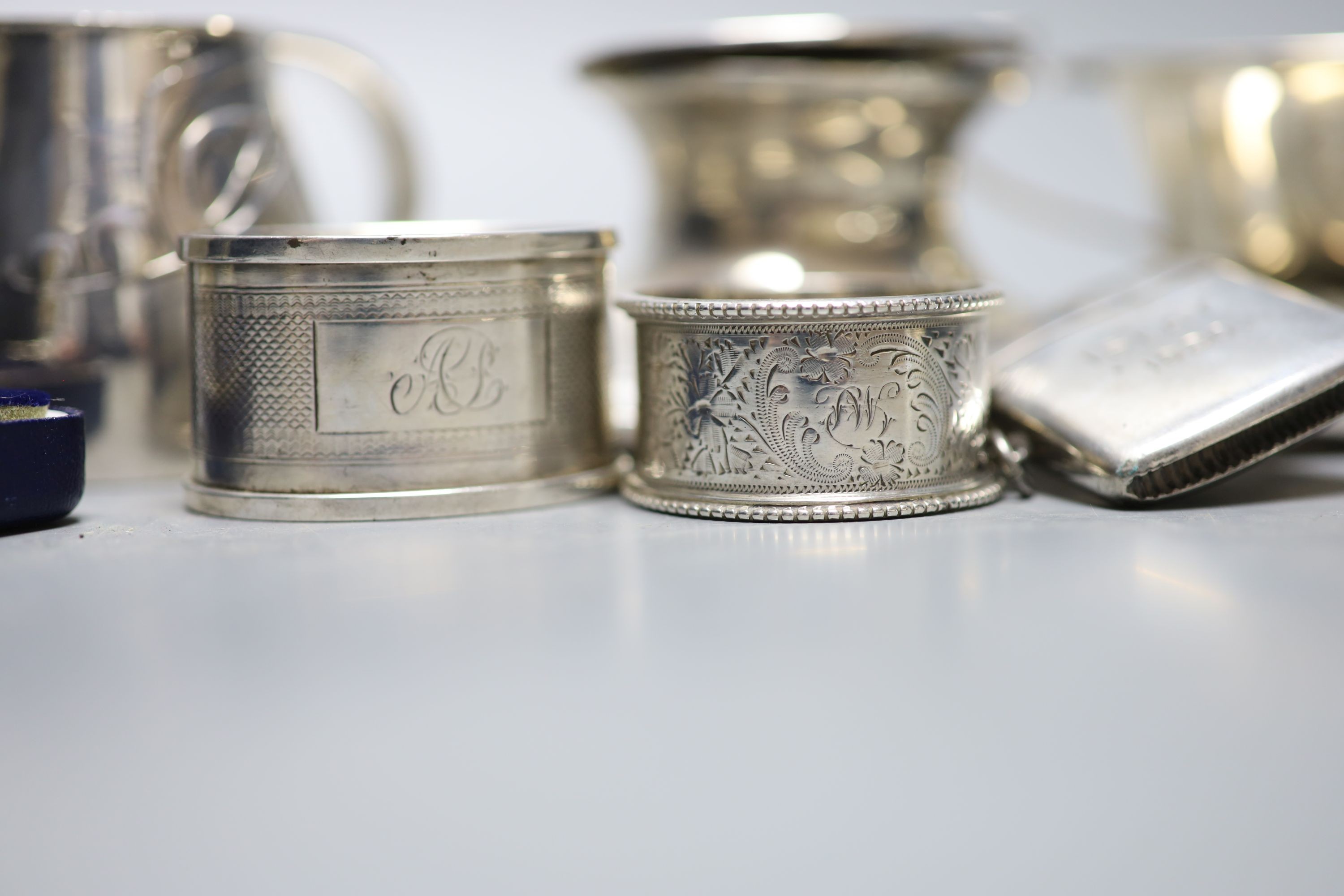 A Scottish silver mounted oval inkwell, 13.2cm, a small silver bowl, silver vesta case, silver cigarette case, two silver napkin rings and two other items.